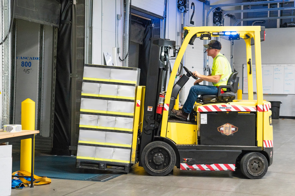 forklift loading a rail container